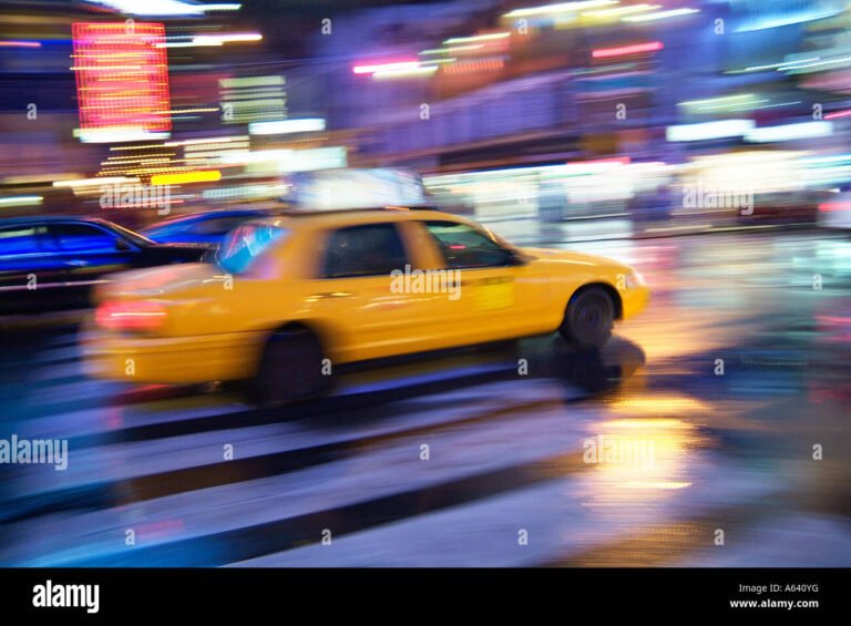 taxi in movimento con la citta sullo sfondo